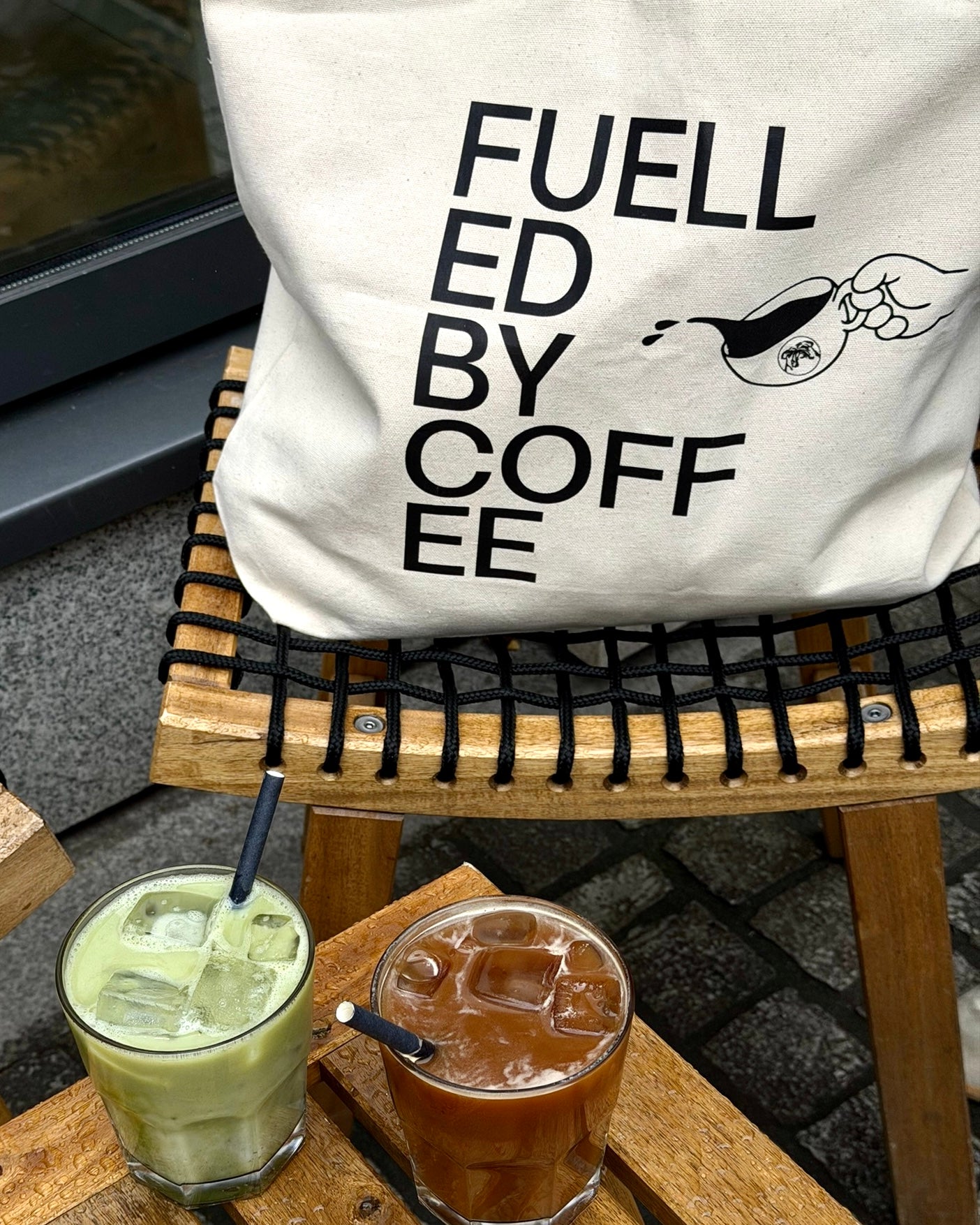 Fuelled by Coffee Tote Outside with coffee and matcha on ice